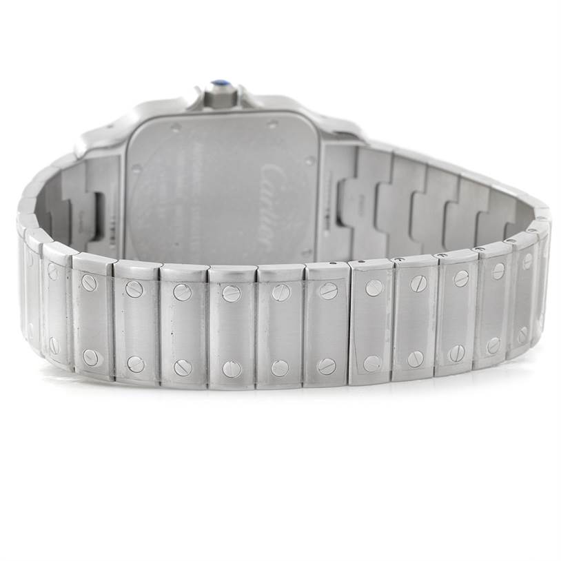 The image shows the back view of the Santos model by Cartier, focusing on the stainless steel bracelet and case back.