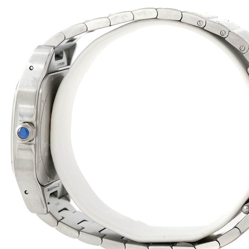The image shows a side view of a Cartier Santos W20098D6 Men
s Stainless Steel Silver Dial W20098D6 Men
s Stainless Steel Silver Dial watch, highlighting the bracelet and the crown with a blue gemstone.
