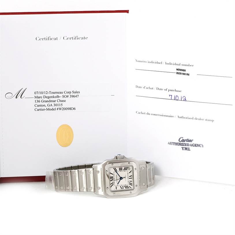 The image shows a Cartier Santos W20098D6 Men
s Stainless Steel Silver Dial W20098D6 Men
s Stainless Steel Silver Dial watch lying flat with its certificate and warranty papers.