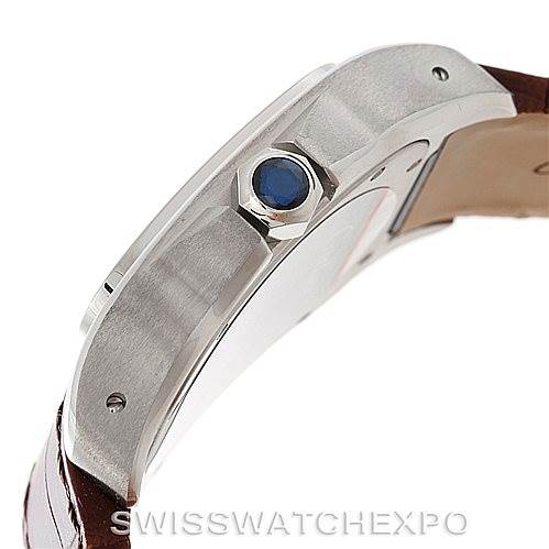 This image shows the side angle of the Santos model watch by Cartier, highlighting the crown with a blue cabochon and part of the strap.