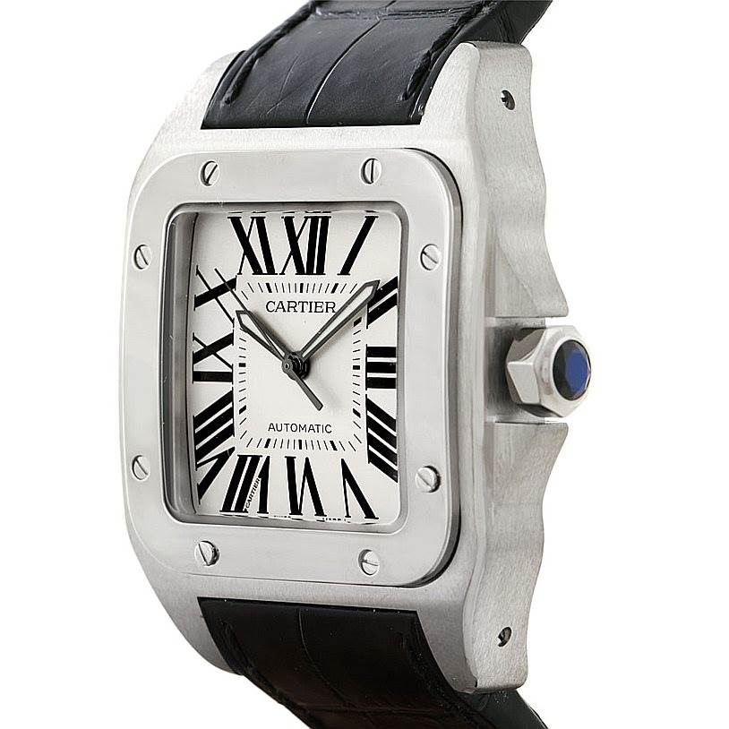 The Cartier Santos W20073X8 Men
s Stainless Steel Silver Dial W20073X8 Men
s Stainless Steel Silver Dial watch is shown at an angle displaying the face, bezel, crown, and part of the black leather strap.