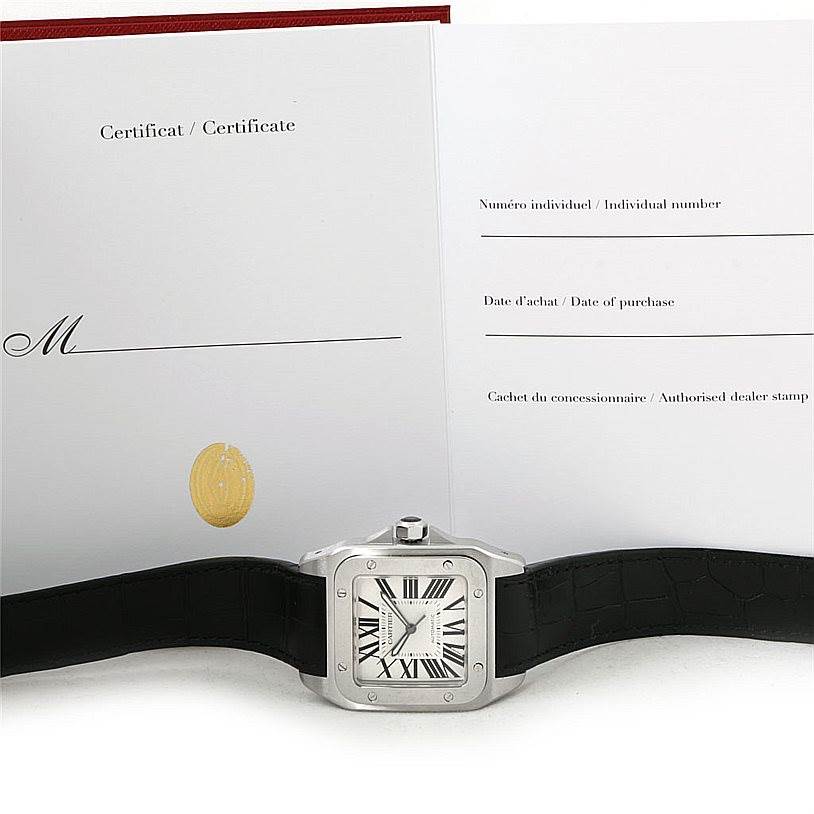 The image shows a Cartier Santos W20073X8 Men
s Stainless Steel Silver Dial W20073X8 Men
s Stainless Steel Silver Dial watch with a leather strap, positioned in front of its certificate.