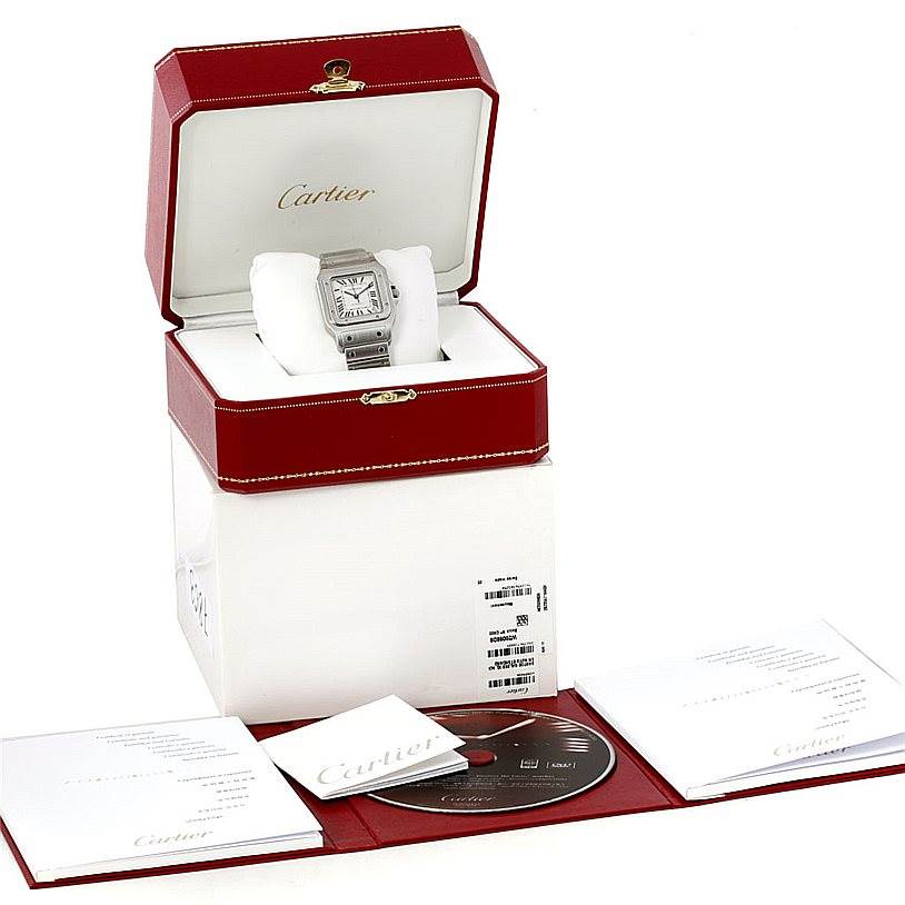 The image shows a Cartier Santos W20098D6 Men's Stainless Steel Silver Dial W20098D6 Men's Stainless Steel Silver Dial watch in its box, along with manuals and a disc.