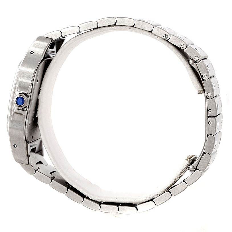 The image shows a side profile of the Cartier Santos W20098D6 Men's Stainless Steel Silver Dial W20098D6 Men's Stainless Steel Silver Dial watch, highlighting its metal bracelet and crown with a blue gemstone.