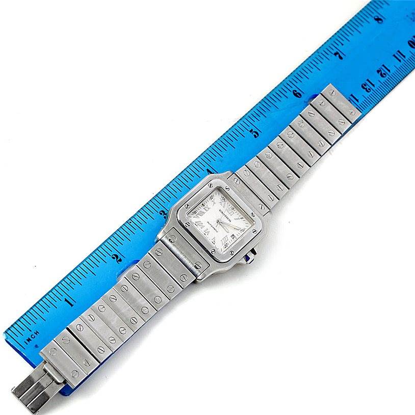 The image shows the Cartier Santos W20055D6 Men's Stainless Steel Silver Dial W20055D6 Men's Stainless Steel Silver Dial watch in a top-down view, aligned with a blue ruler for measurement.