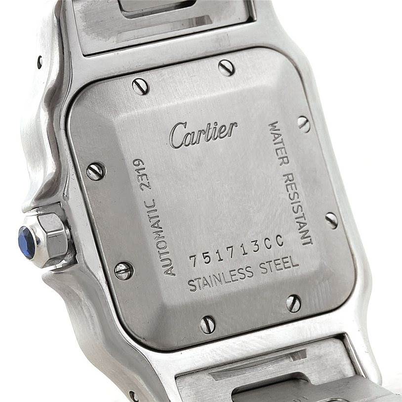 The image shows the back case of a Cartier Santos W20055D6 Men's Stainless Steel Silver Dial W20055D6 Men's Stainless Steel Silver Dial watch, highlighting its screws, engraving, and stainless steel material.