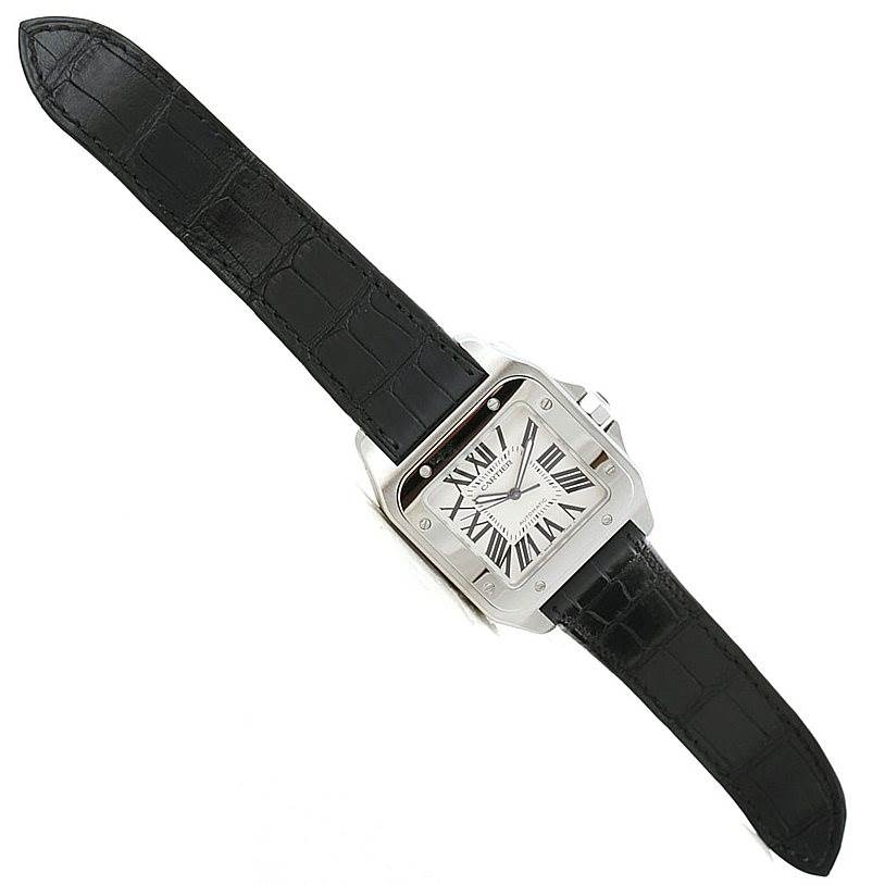 The image shows a Cartier Santos W20073X8 Men
s Stainless Steel Silver Dial W20073X8 Men
s Stainless Steel Silver Dial watch displayed face-up with a black leather strap and a square dial.