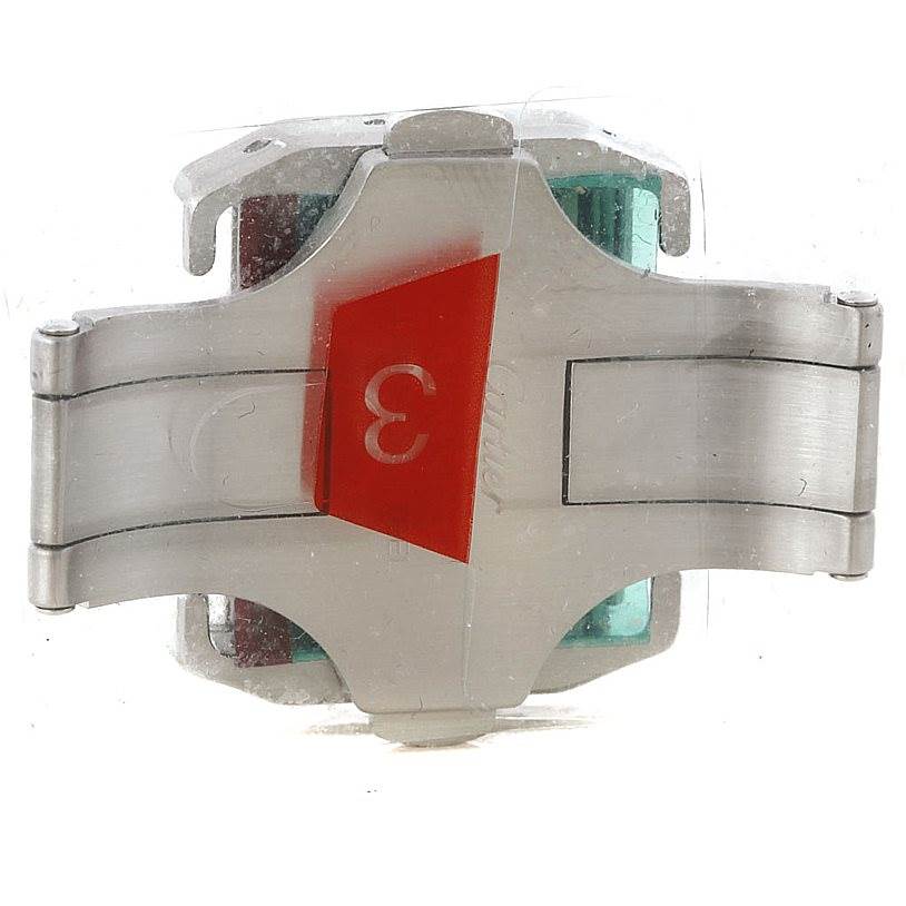 The image shows a close-up of the clasp mechanism of a Santos model Cartier watch, viewed from the underside.