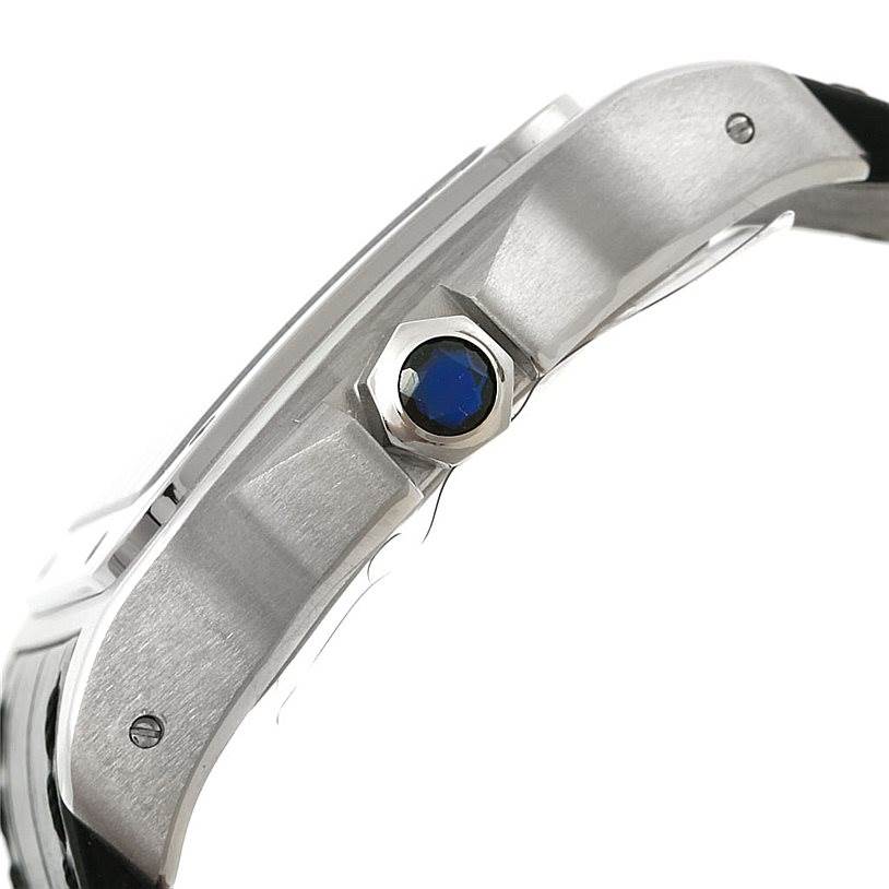 This side view of the Cartier Santos W20073X8 Men
s Stainless Steel Silver Dial W20073X8 Men
s Stainless Steel Silver Dial watch shows the crown with a blue gemstone.
