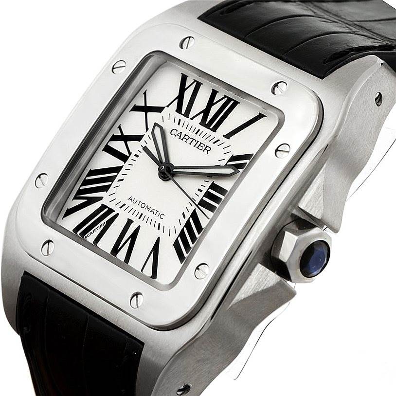 This image shows a close-up angled view of the Cartier Santos W20073X8 Men
s Stainless Steel Silver Dial W20073X8 Men
s Stainless Steel Silver Dial watch face, crown, and part of the leather strap.