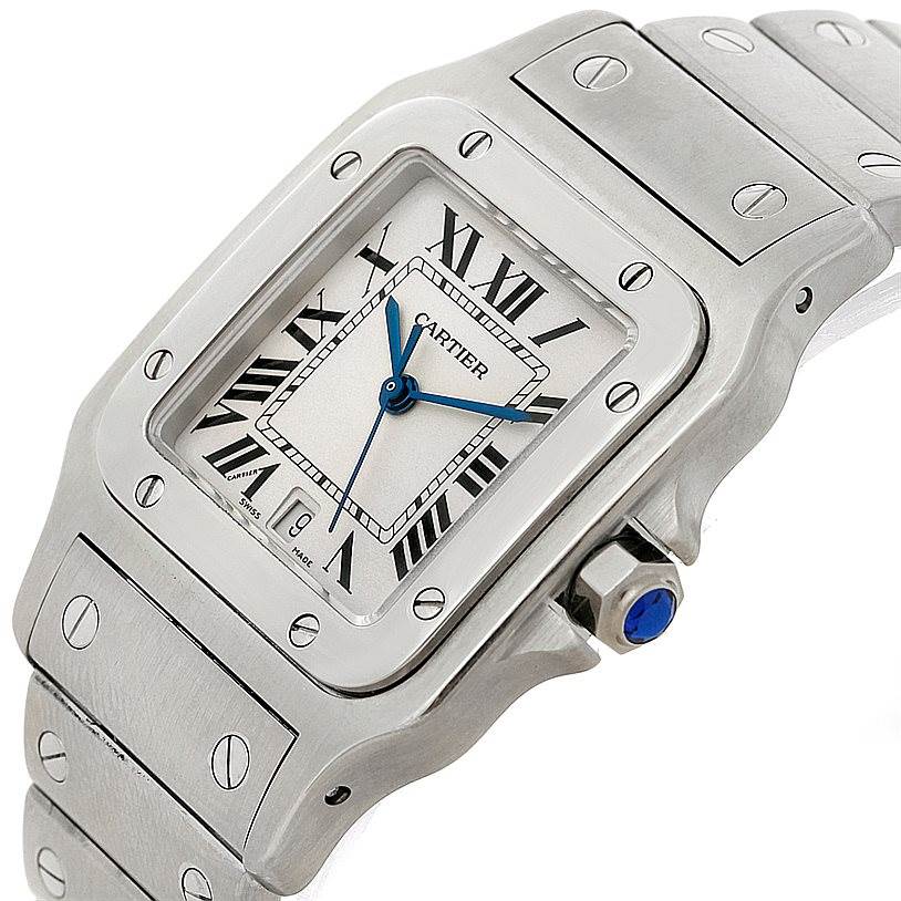 The image shows a close-up view of the Cartier Santos W20060D6 Men's Stainless Steel Silver Dial W20060D6 Men's Stainless Steel Silver Dial watch face and part of its metal bracelet.