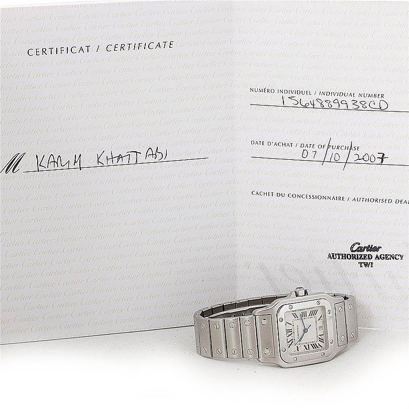 The image shows a Cartier Santos W20060D6 Men's Stainless Steel Silver Dial W20060D6 Men's Stainless Steel Silver Dial model watch laying flat with its certificate in the background.