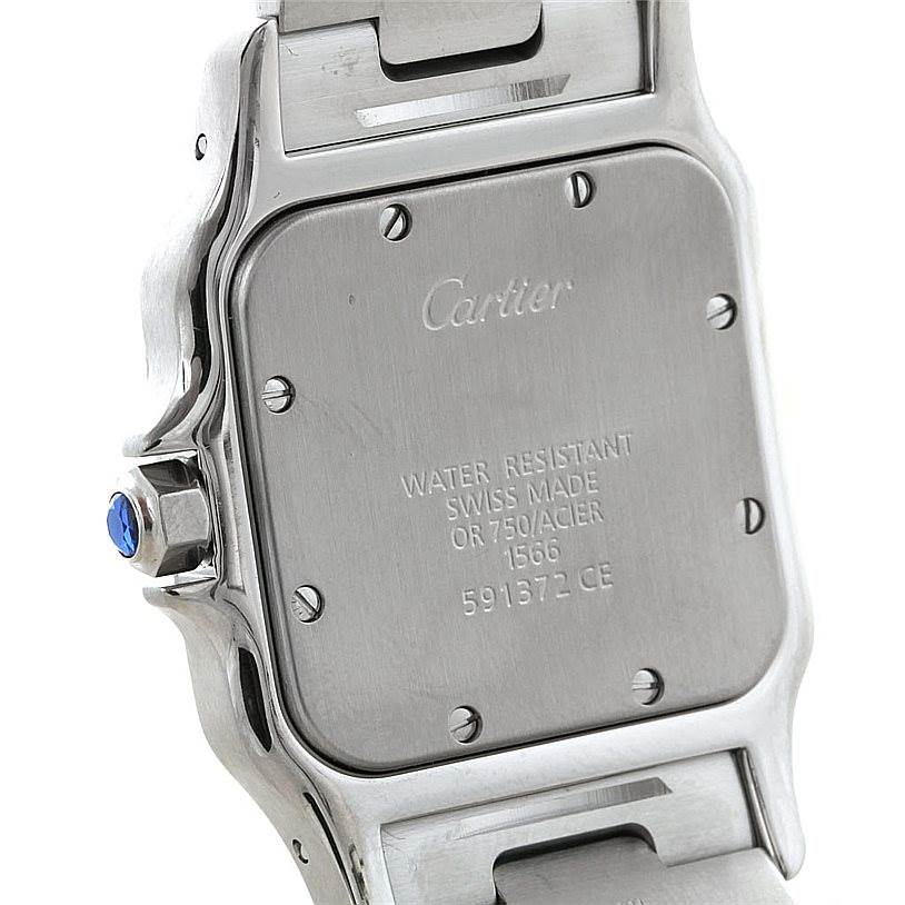 This image shows the back case and part of the bracelet of a Santos model by Cartier, including the crown with a blue gemstone.