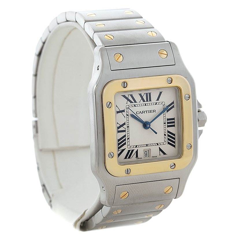 The image shows a front-facing angle of the Santos model by Cartier, highlighting its square face, Roman numerals, and metallic strap.