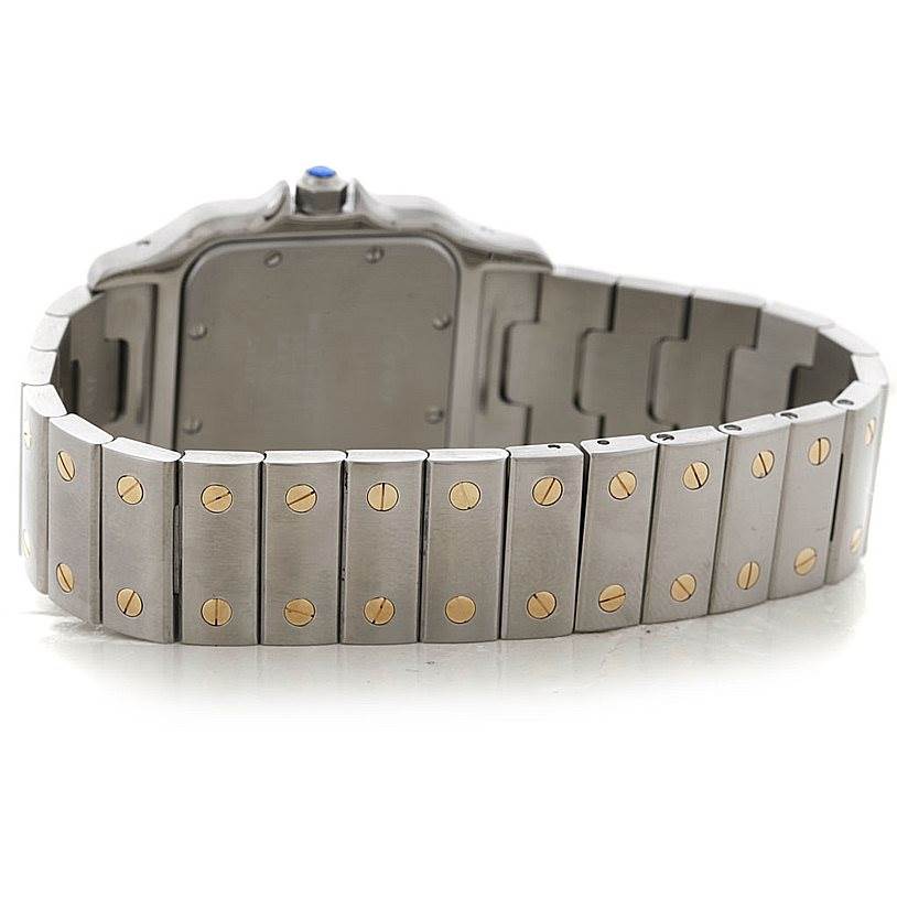 The image shows the backside of the bracelet and caseback of a Cartier Santos W20011C4 Men
s Stainless Steel Silver Dial W20011C4 Men
s Stainless Steel Silver Dial watch, highlighting the links and clasp.