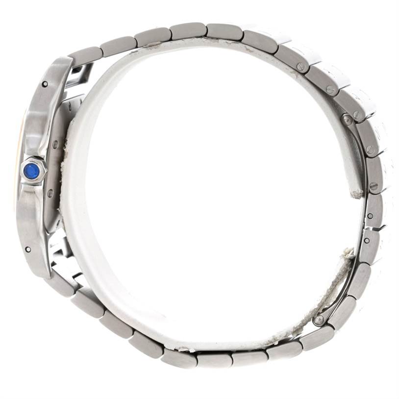 The image shows a Cartier Santos W20058C4 Men
s Stainless Steel Silver Dial W20058C4 Men
s Stainless Steel Silver Dial watch from a side view, displaying the bracelet and the crown with blue detailing.