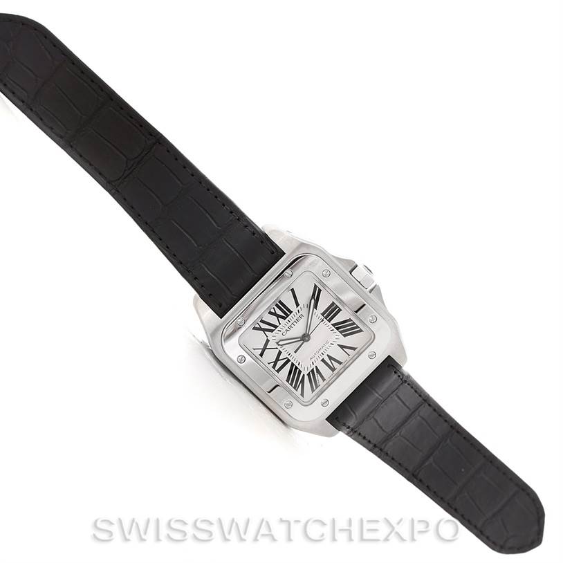 This Cartier Santos W20073X8 Men
s Stainless Steel Silver Dial W20073X8 Men
s Stainless Steel Silver Dial model watch is shown from an overhead angle, displaying its face and black leather strap.