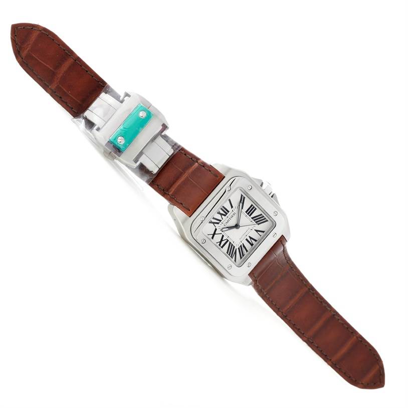 The image shows a top-down view of the Santos model by Cartier, displaying its brown leather strap and square face with Roman numerals.