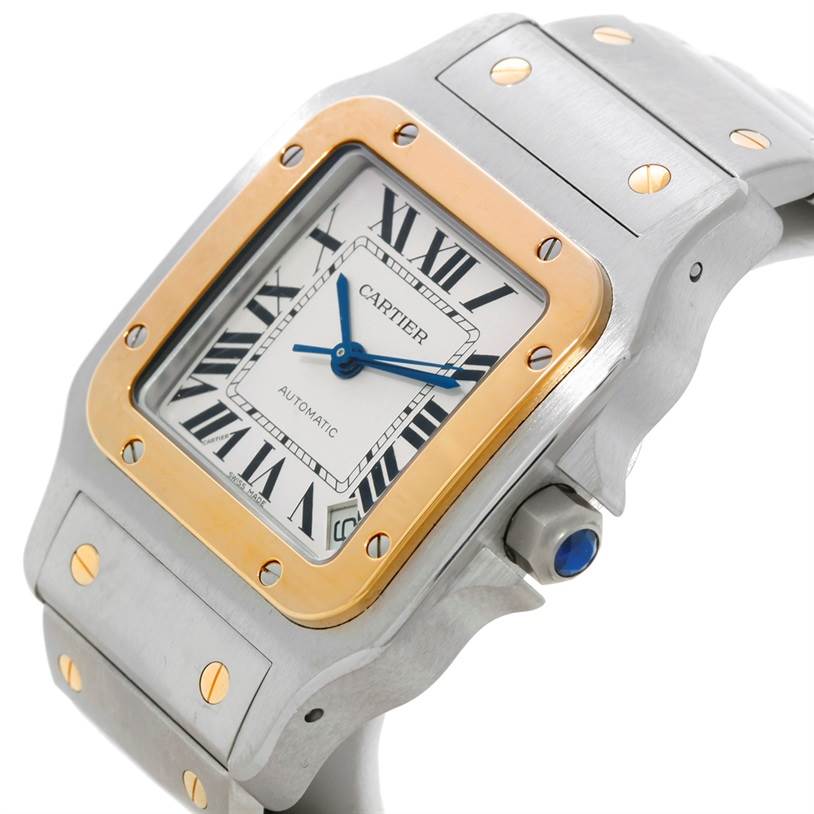 The image shows a close-up of the Santos model watch by Cartier, focusing on the bezel, dial, and part of the bracelet at an angle.
