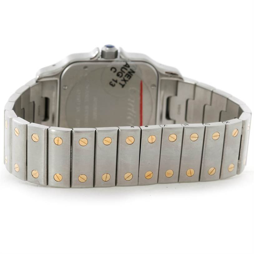 The image shows the back view of a Santos model watch by Cartier, highlighting its bracelet and clasp.