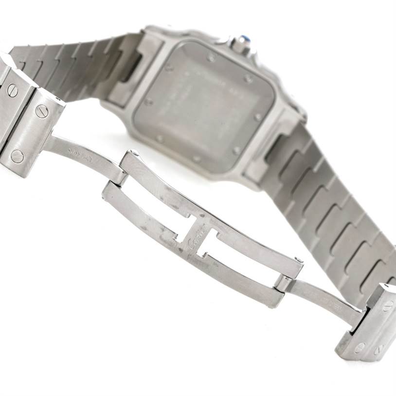 The image shows the backside and clasp of a Santos model Cartier watch, highlighting the bracelet and deployment clasp. 