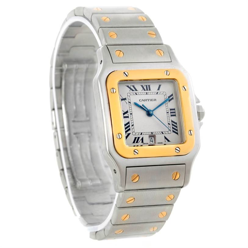 The image shows a Cartier Santos W20011C4 Stainless Steel Silver Dial W20011C4 Stainless Steel Silver Dial watch at an oblique angle, highlighting its square dial, metal band, and gold bezel screws.