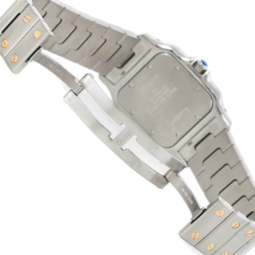 The image shows the underside of a Cartier Santos W20011C4 Stainless Steel Silver Dial W20011C4 Stainless Steel Silver Dial model watch, focusing on the clasp, bracelet, and case back.