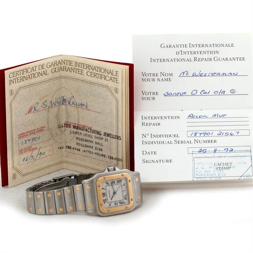 The image shows the Cartier Santos Stainless Steel Silver Dial Stainless Steel Silver Dial watch lying flat, accompanied by its guarantee and repair certificates displayed around it.