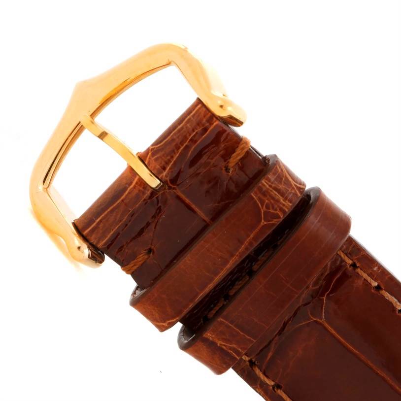 This image shows a close-up of the brown leather strap and gold buckle of the Cartier Tank Louis W1529756 Men's Yellow Gold Silver Dial W1529756 Men's Yellow Gold Silver Dial watch.