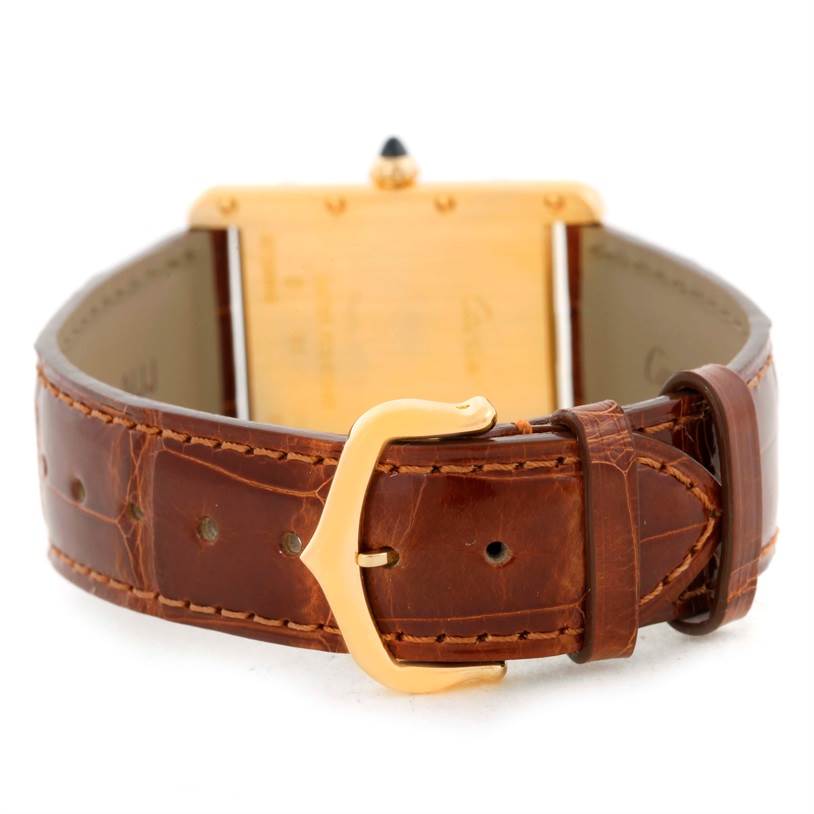 The image shows the back and side of a Cartier Tank Louis W1529756 Men's Yellow Gold Silver Dial W1529756 Men's Yellow Gold Silver Dial watch, highlighting its leather strap and gold buckle.