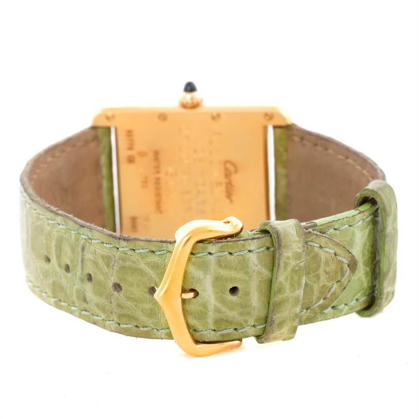 This image shows the back of a Cartier Tank Louis W1529756 Men's Yellow Gold Silver Dial W1529756 Men's Yellow Gold Silver Dial model watch, focusing on the green leather strap and gold buckle.