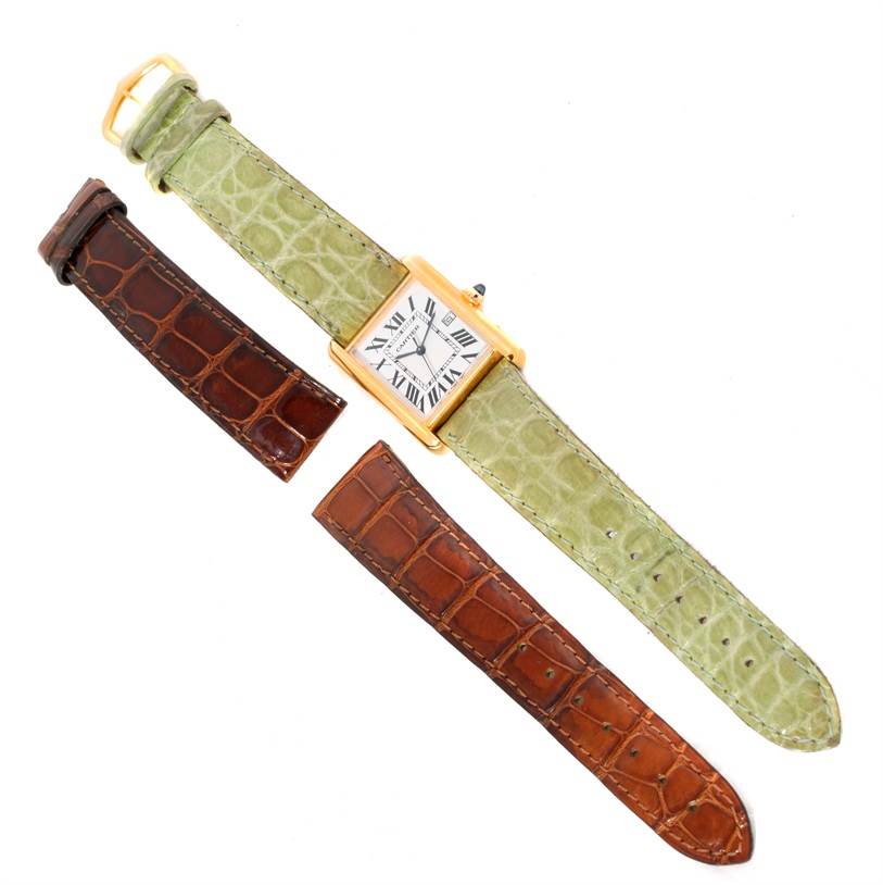 The image shows a Cartier Tank Louis W1529756 Men's Yellow Gold Silver Dial W1529756 Men's Yellow Gold Silver Dial model watch with a green strap and two additional brown straps from a top view.