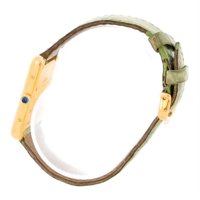 The image shows the side view of a Cartier Tank Louis W1529756 Men's Yellow Gold Silver Dial W1529756 Men's Yellow Gold Silver Dial watch with a green leather strap and gold case.