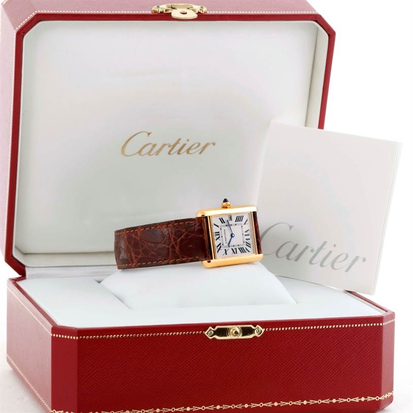 A Cartier Tank Louis W1529756 Yellow Gold Silver Dial W1529756 Yellow Gold Silver Dial watch is shown from a frontal angle within its red presentation box alongside its booklet.