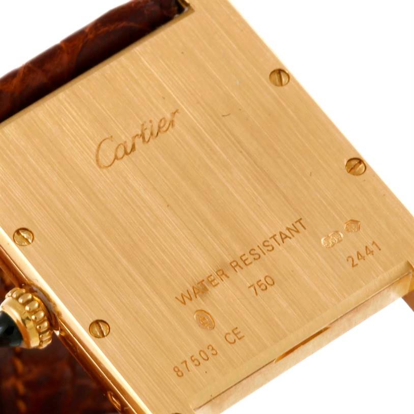 This image shows the back of the Cartier Tank Louis W1529756 Yellow Gold Silver Dial W1529756 Yellow Gold Silver Dial watch, highlighting the markings and screws.
