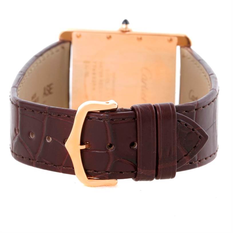 The image shows the back view of a Cartier Tank Louis W1560017 Men's Rose Gold Silver Dial W1560017 Men's Rose Gold Silver Dial watch, highlighting the leather strap and gold buckle.