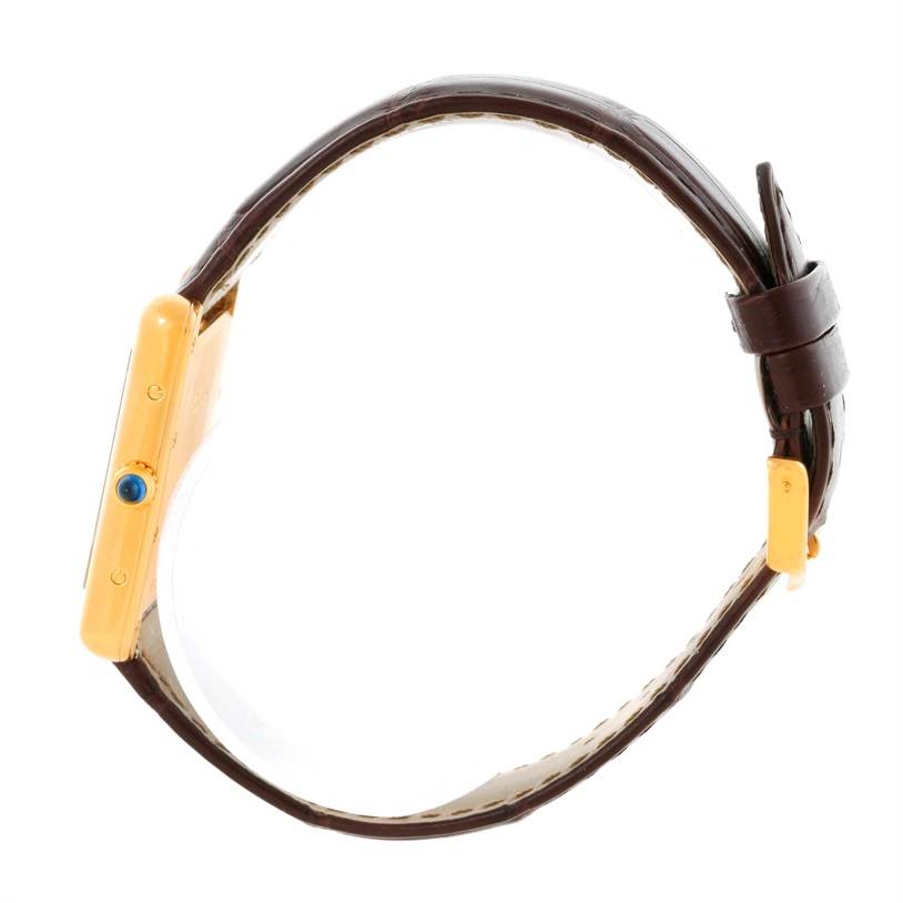 The image shows a side view of the Cartier Tank Louis W1529756 Men's Yellow Gold Silver Dial W1529756 Men's Yellow Gold Silver Dial model watch, including its crown and brown leather strap.