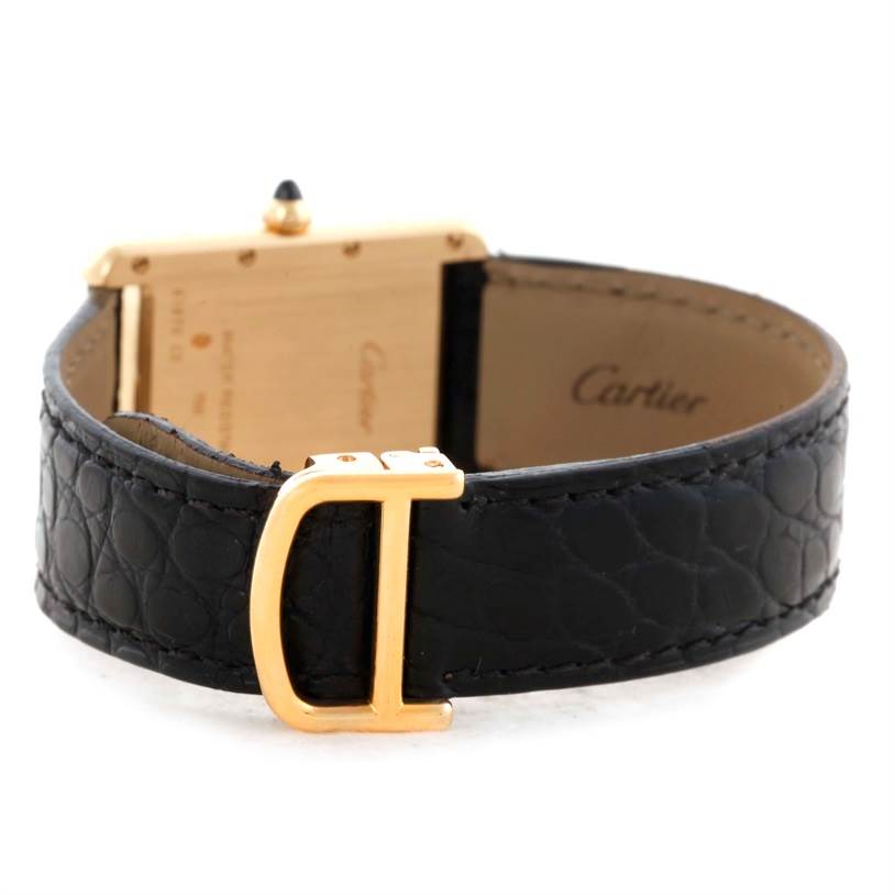 The image shows the back and strap of Cartier's Tank Louis watch, highlighting the buckle and case back.