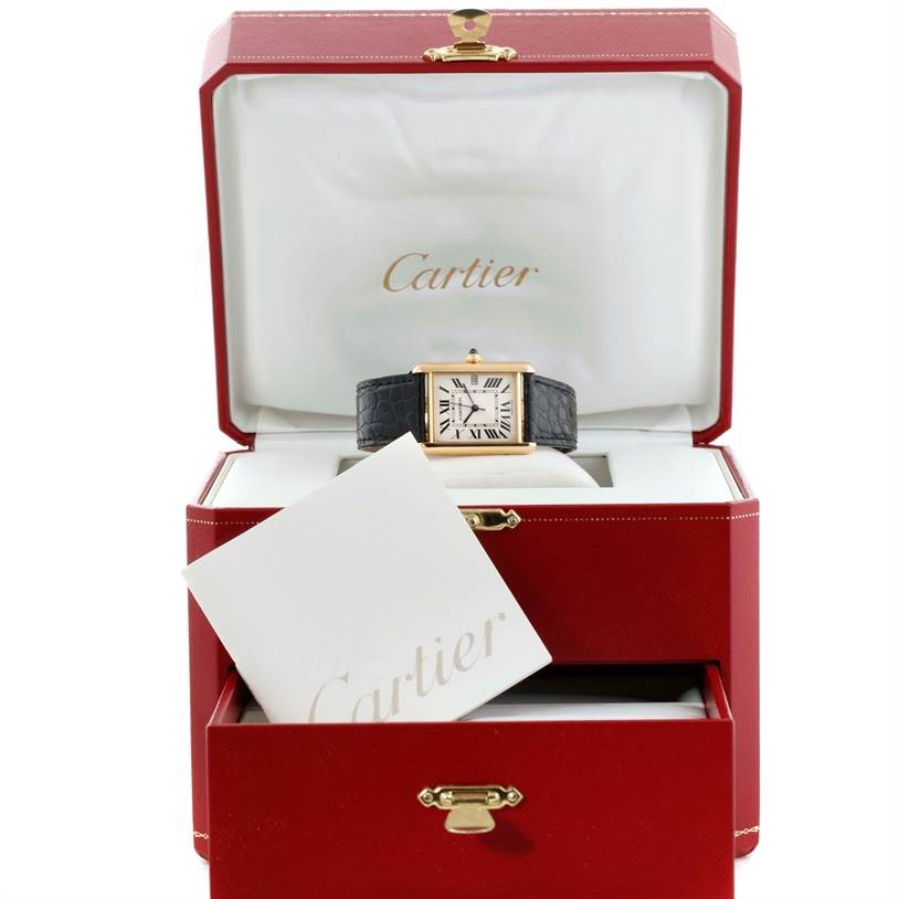 The image shows a Cartier Tank Louis W1529756 Men's Yellow Gold Silver Dial W1529756 Men's Yellow Gold Silver Dial watch in a red Cartier box, with a booklet in front of it.