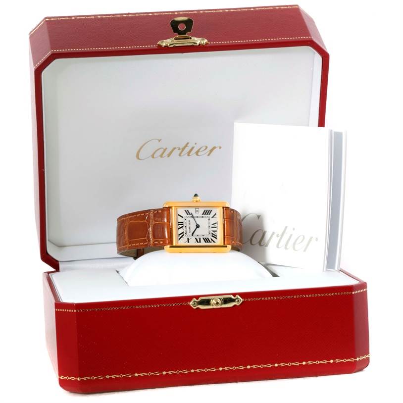 The Cartier Tank Louis Men's Yellow Gold Silver Dial Men's Yellow Gold Silver Dial watch is shown front-facing in its open red box along with documentation.