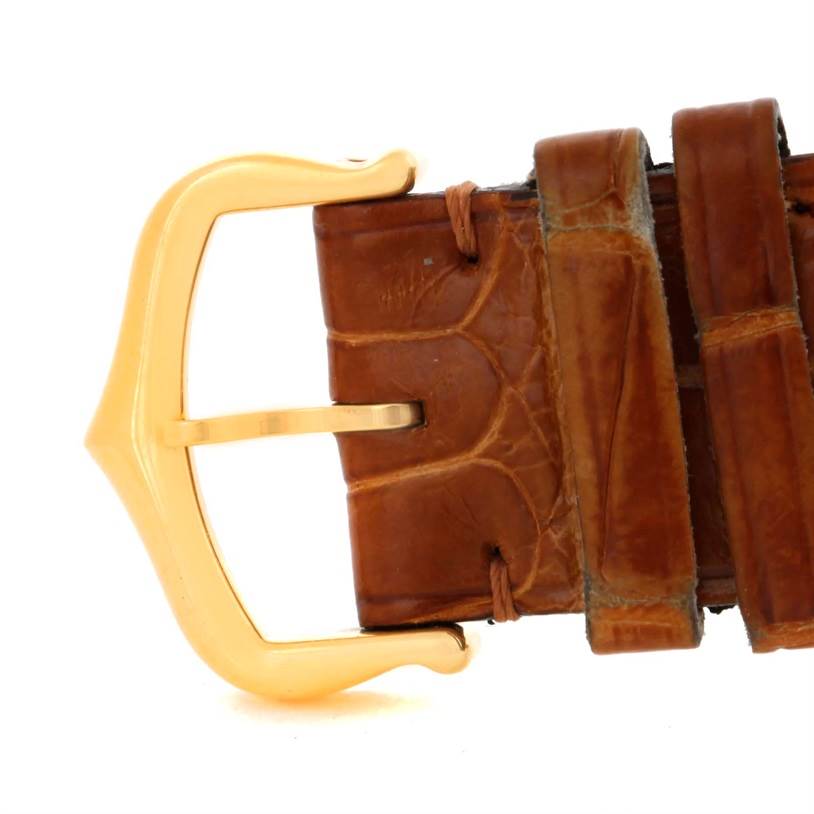 This is a close-up of the buckle and strap of the Cartier Tank Louis Men's Yellow Gold Silver Dial Men's Yellow Gold Silver Dial watch.