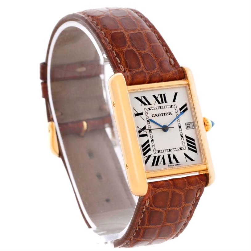 The Tank Louis model by Cartier is shown at a slight side angle, highlighting its gold case, white dial, Roman numerals, and brown leather strap.