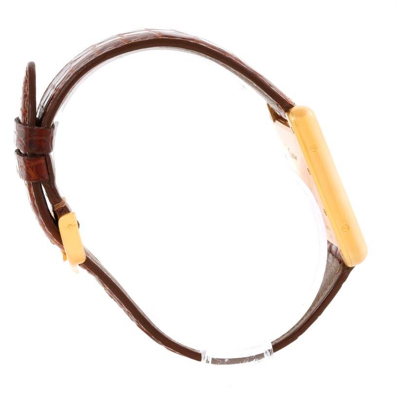 This side-angle view of the Cartier Tank Louis W1529756 Men's Yellow Gold Silver Dial W1529756 Men's Yellow Gold Silver Dial model watch shows the strap, buckle, and case.