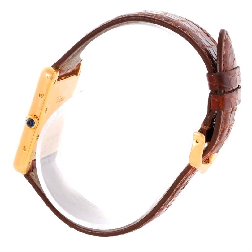 The image shows a Cartier Tank Louis W1529756 Men's Yellow Gold Silver Dial W1529756 Men's Yellow Gold Silver Dial watch in a side view, highlighting its gold case, blue cabochon crown, and brown leather strap.