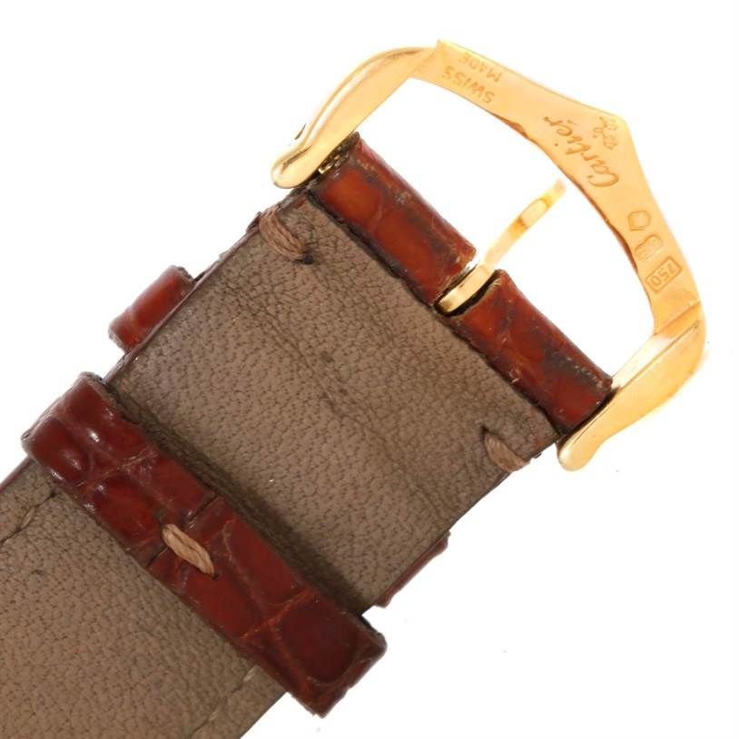 This image shows the leather strap and gold buckle of a Cartier Tank Louis W1529756 Men's Yellow Gold Silver Dial W1529756 Men's Yellow Gold Silver Dial watch at a close-up angle.