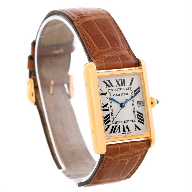 The Cartier Tank Louis W1529756 Men's Yellow Gold Silver Dial W1529756 Men's Yellow Gold Silver Dial watch is shown at a slight angle, displaying its rectangular face, Roman numerals, leather strap, and gold casing.