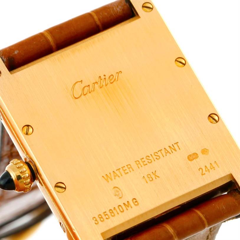 This image shows the back of a Cartier Tank Louis W1529756 Men's Yellow Gold Silver Dial W1529756 Men's Yellow Gold Silver Dial watch, focusing on the inscriptions and leather strap attachments.