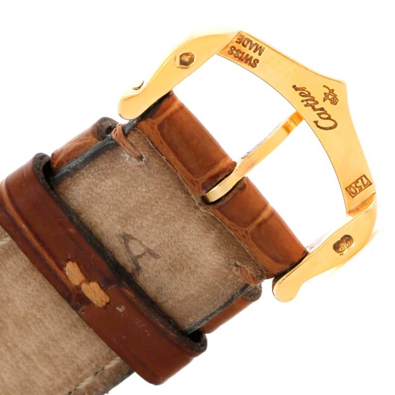 The image shows a close-up of the buckle and strap of a Cartier Tank Louis W1529756 Men's Yellow Gold Silver Dial W1529756 Men's Yellow Gold Silver Dial watch, focusing on the gold buckle and brown leather strap.