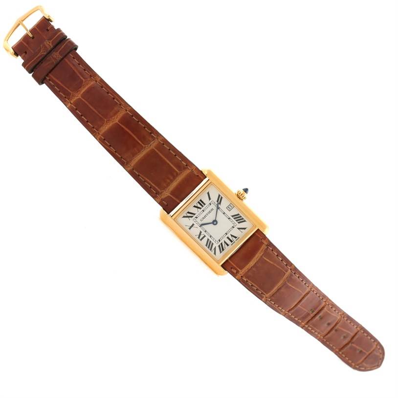 The watch is shown from a top-down angle, displaying the face and brown leather strap of the Cartier Tank Louis W1529756 Men's Yellow Gold Silver Dial W1529756 Men's Yellow Gold Silver Dial model.