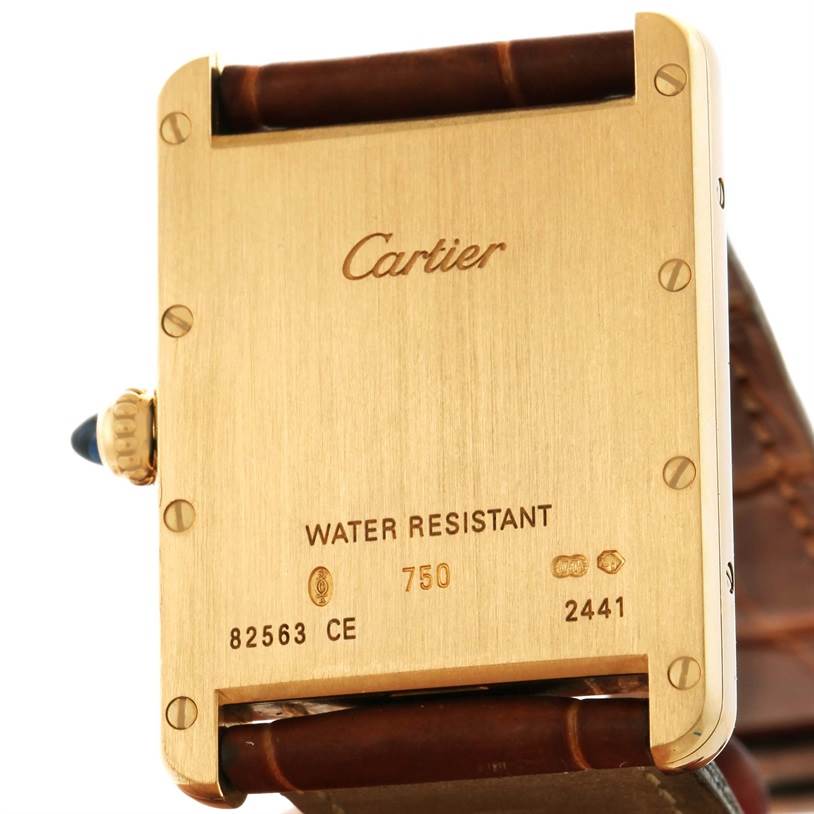 The image shows the back casing and part of the strap of the Cartier Tank Louis W1529756 Men's Yellow Gold Silver Dial W1529756 Men's Yellow Gold Silver Dial watch.